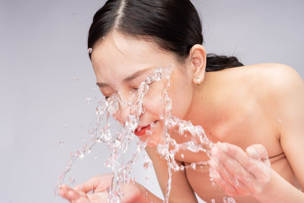 Woman with Sensitive Skin Washes Her Face with Pure Water