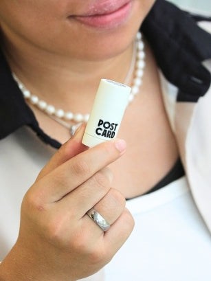 woman holding a body balm