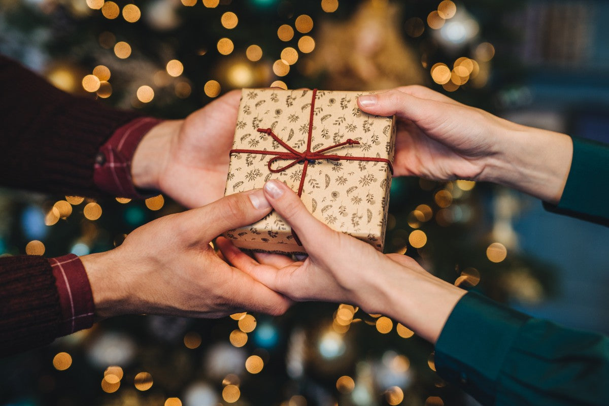 hands exchanging christmas gift